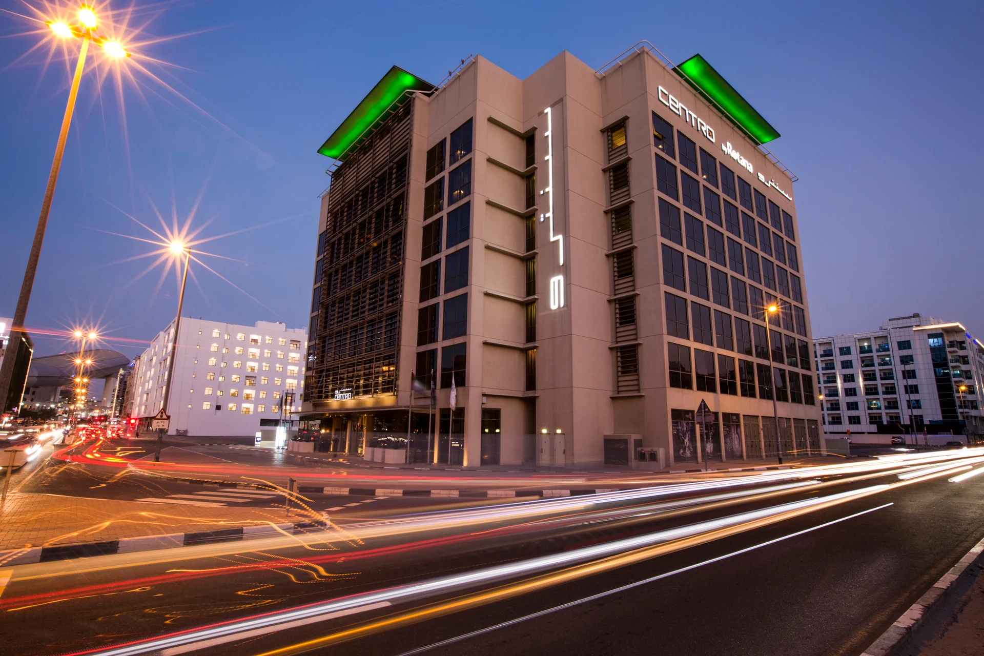 a hotel building with lights on the side of it