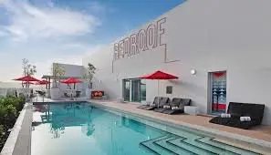 a swimming pool with umbrellas and chairs